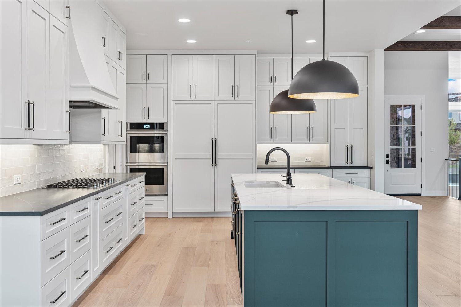 Central island and wall ovens in Carr Estates Ranch custom Spec home in Westminster, CO kitchen Central island and wall ovens in Carr Estates Ranch custom Spec home in Westminster, CO kitchen