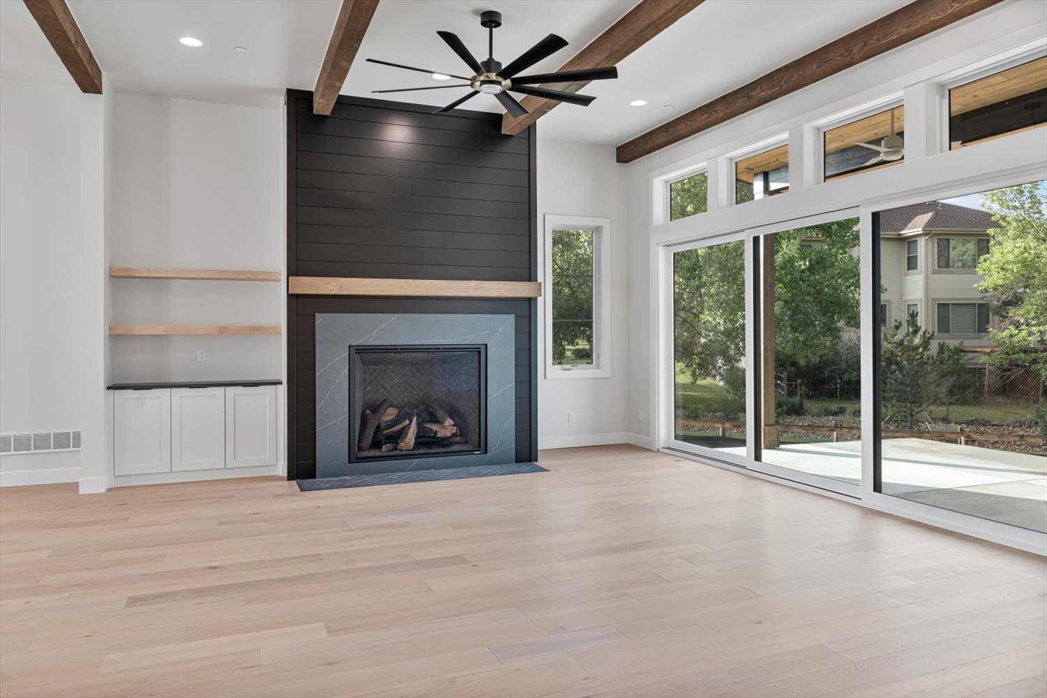 Fireplace with floor-to-ceiling windows in Carr Estates Ranch custom Spec home in Westminster, CO great room Fireplace with floor-to-ceiling windows in Carr Estates Ranch custom Spec home in Westminster, CO great room