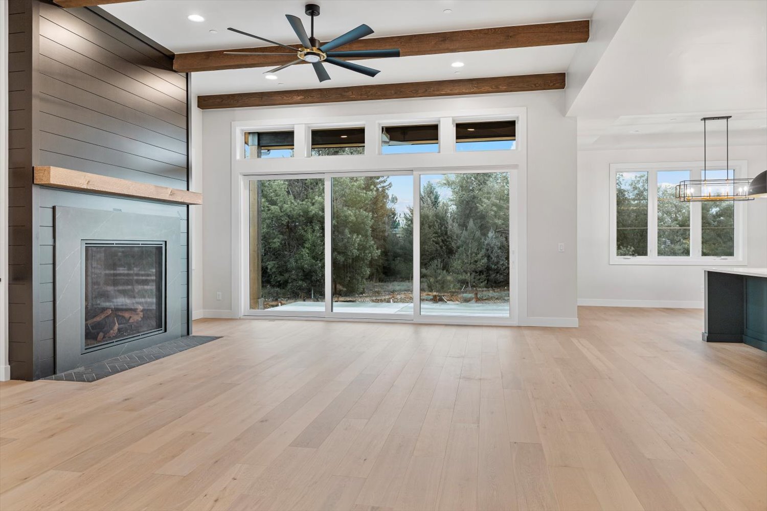 Spacious great room in Carr Estates Ranch custom Spec home in Westminster, CO with large windows and fireplace Spacious great room in Carr Estates Ranch custom Spec home in Westminster, CO with large windows and fireplace