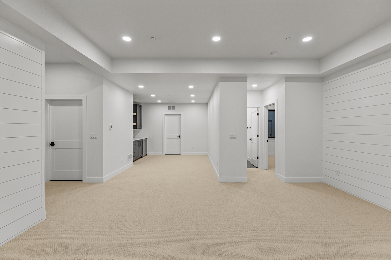 Large basement rec room with white shiplap accents and beige carpeting in Denver, CO Large basement rec room with white shiplap accents and beige carpeting in Denver, CO