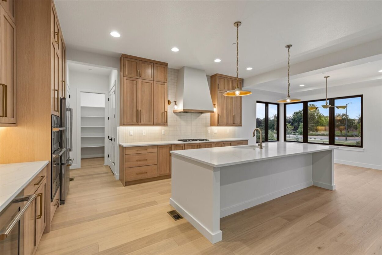 Luxury spec home in Denver, CO with open kitchen layout and expansive windows Luxury spec home in Denver, CO with open kitchen layout and expansive windows