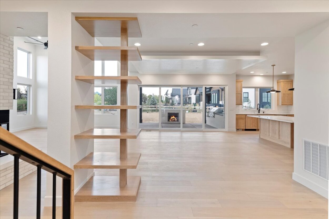 Open-concept entryway of a Denver, CO luxury custom home with modern built-in shelving and natural wood floors Open-concept entryway of a Denver, CO luxury custom home with modern built-in shelving and natural wood floors