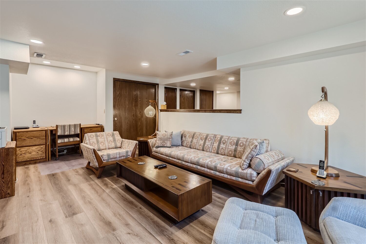 Finished basement living room with modern gray couches, part of a Sheffield Homes basement project in Arvada, CO