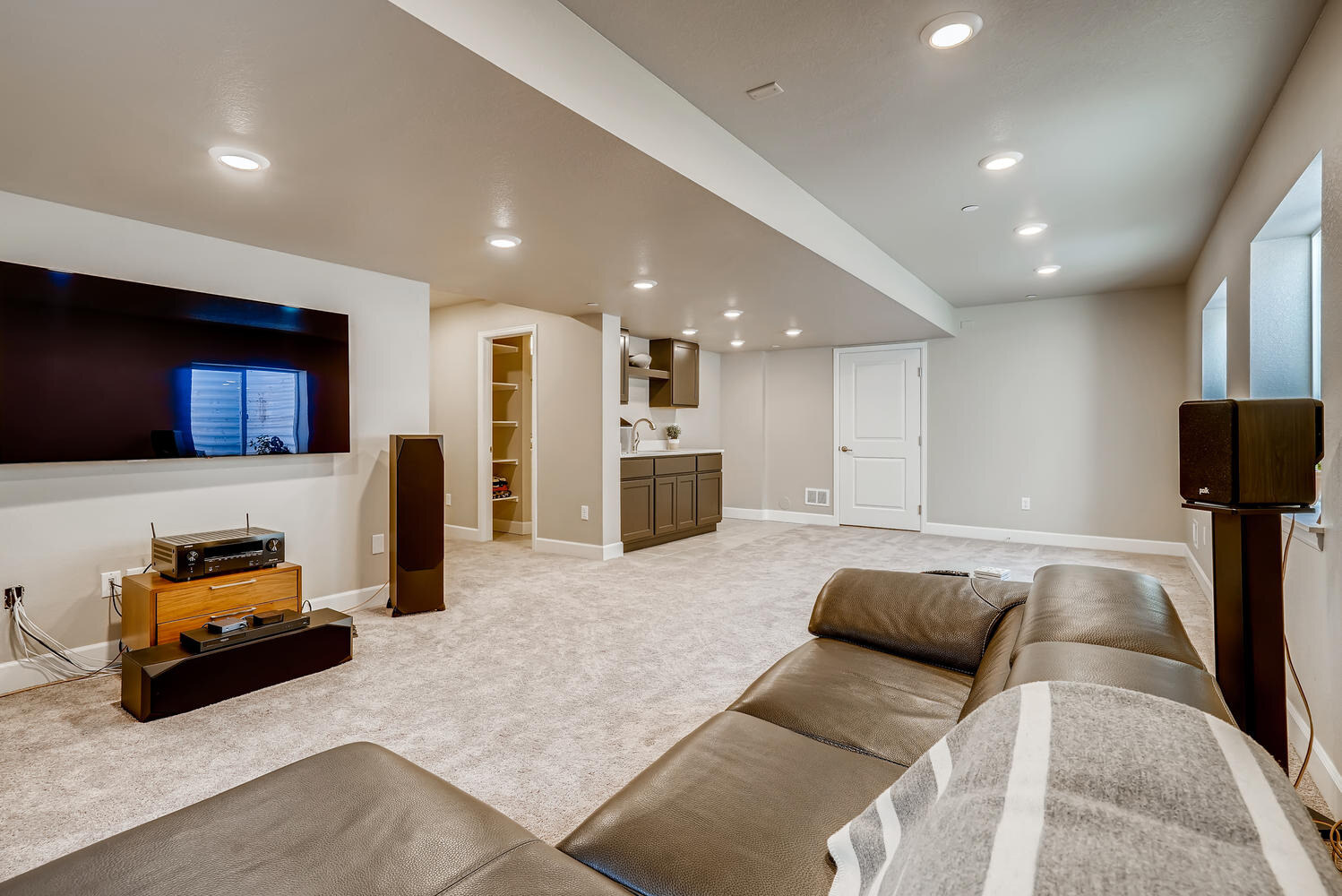 Inviting living room with sectional seating and modern entertainment setup, Sheffield Homes project in Arvada, CO