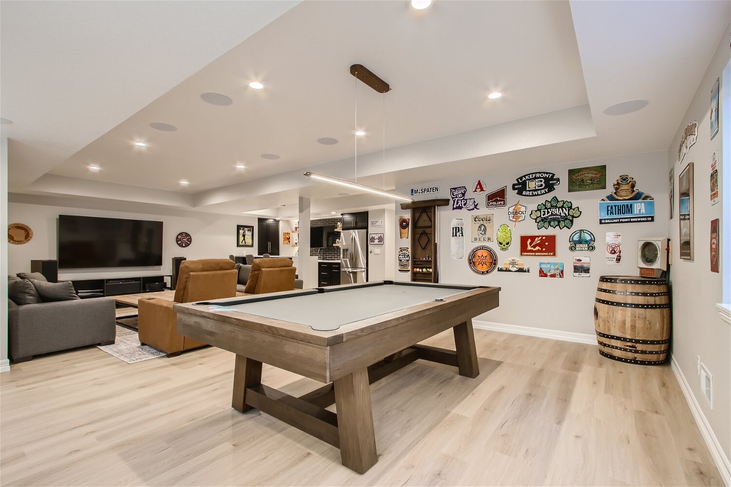 Spacious basement family room with pool table and media area, part of a Sheffield Homes basement finishing in Arvada, CO