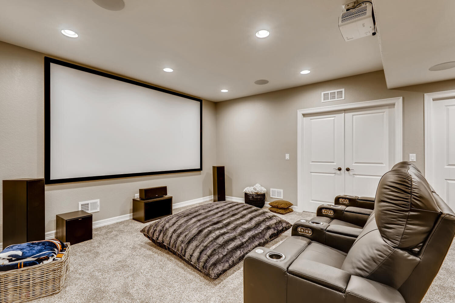 Stylish great room with a fireplace and large windows, Broomfield, CO by Sheffield Homes