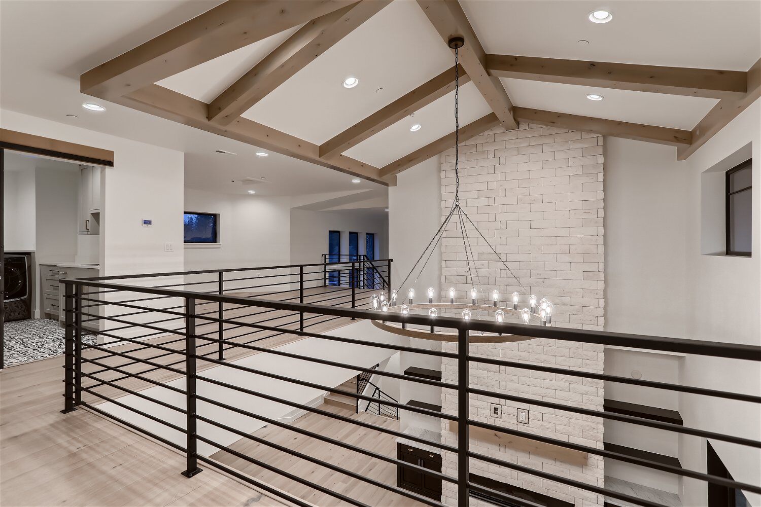 Second-floor hallway with metal railings in a custom home by Sheffield Homes in Evergreen, CO