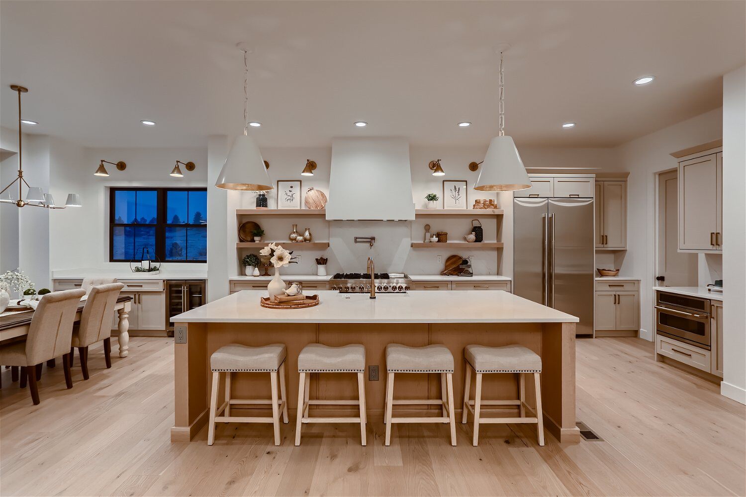 Open kitchen with sleek cabinetry and a stylish dining table in a custom home by Sheffield Homes in Franktown, CO