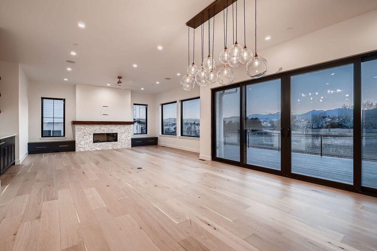 Open concept living room with floor-to-ceiling windows in a custom home by Sheffield Homes in Denver, CO Open concept living room with floor-to-ceiling windows in a custom home by Sheffield Homes in Denver, CO