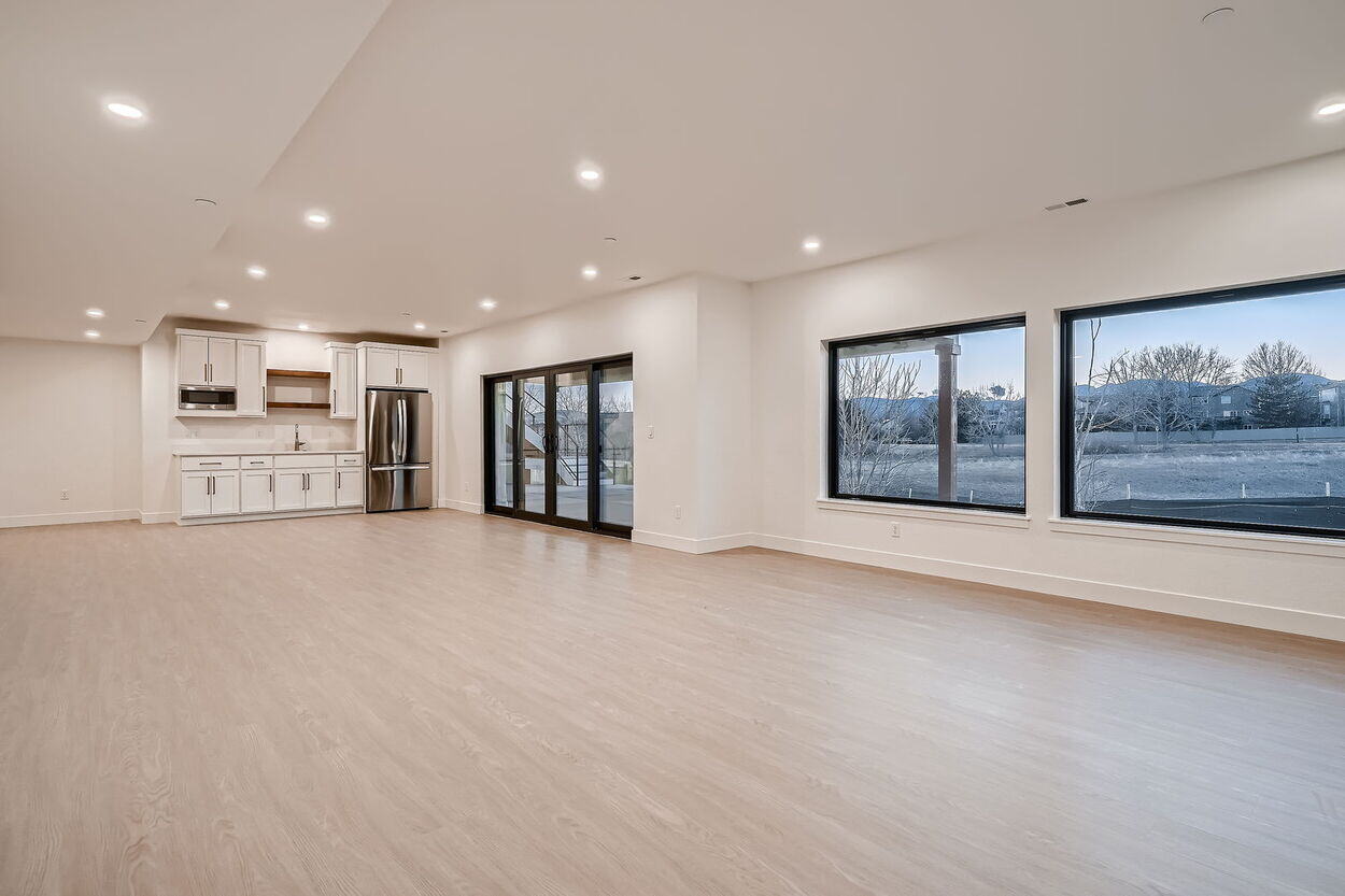 Spacious basement living area with large windows in custom home by Sheffield Homes in Denver, CO Spacious basement living area with large windows in custom home by Sheffield Homes in Denver, CO